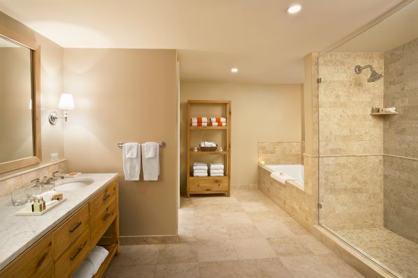 Sanderling Resort's modern bathroom with a shower, tub, sink, and towels.